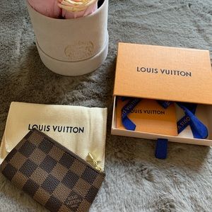 Louis Vuitton key pouch in Damier Ebene canvas.